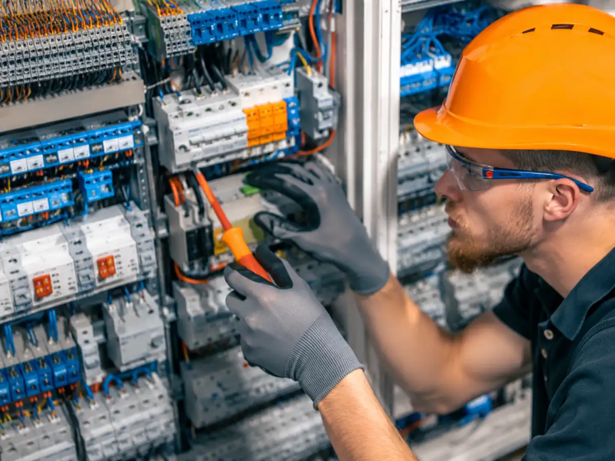 Electrician repairing commercial electrical control panel